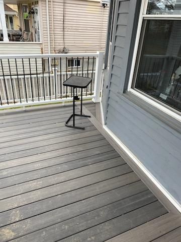 Deck with black stand and gray siding.