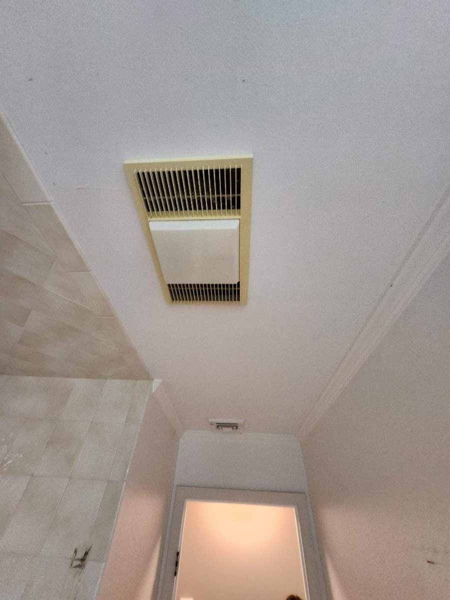 Bathroom ceiling with a ventilation fan and light fixture.