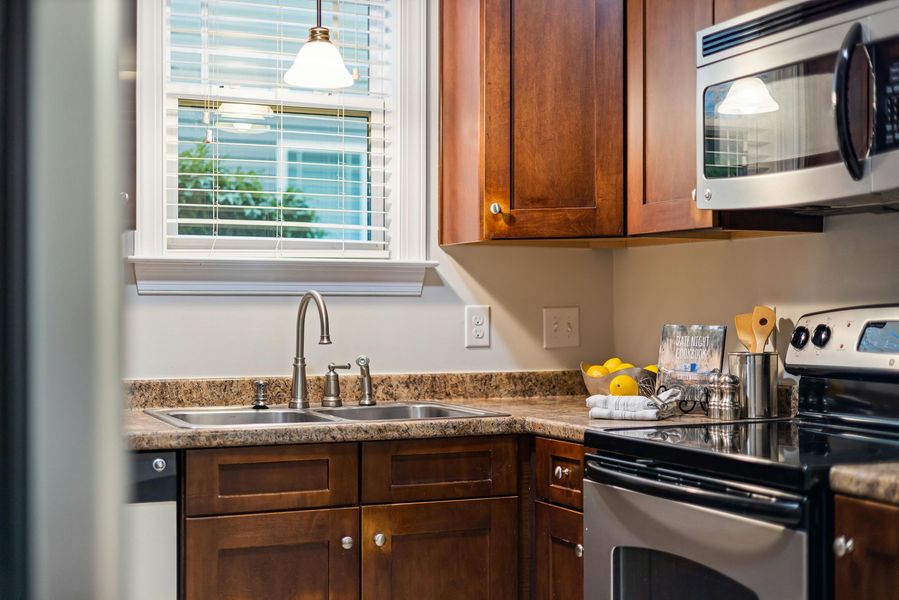 A kitchen with stainless steel appliances and wooden cabinets