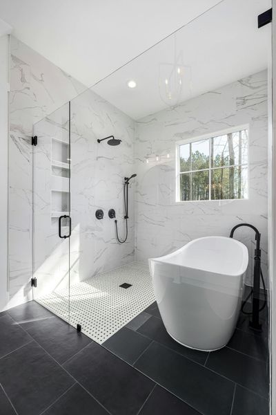 A bathroom with a bathtub and a walk in shower.