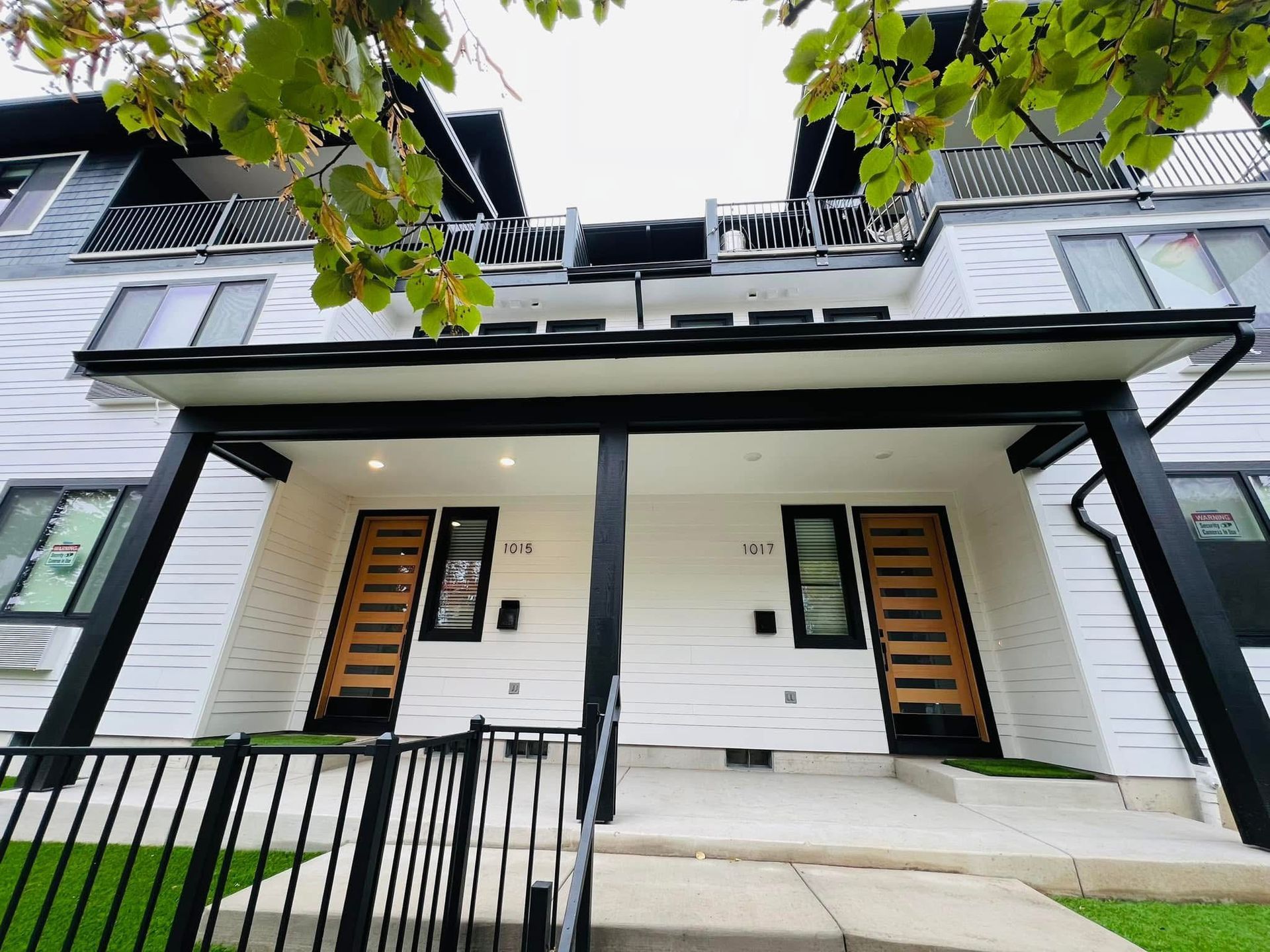 A white house with a black porch and stairs