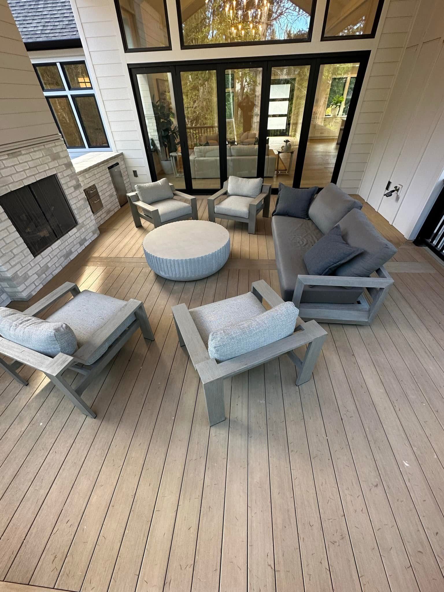 An aerial view of a patio with furniture and a fireplace.