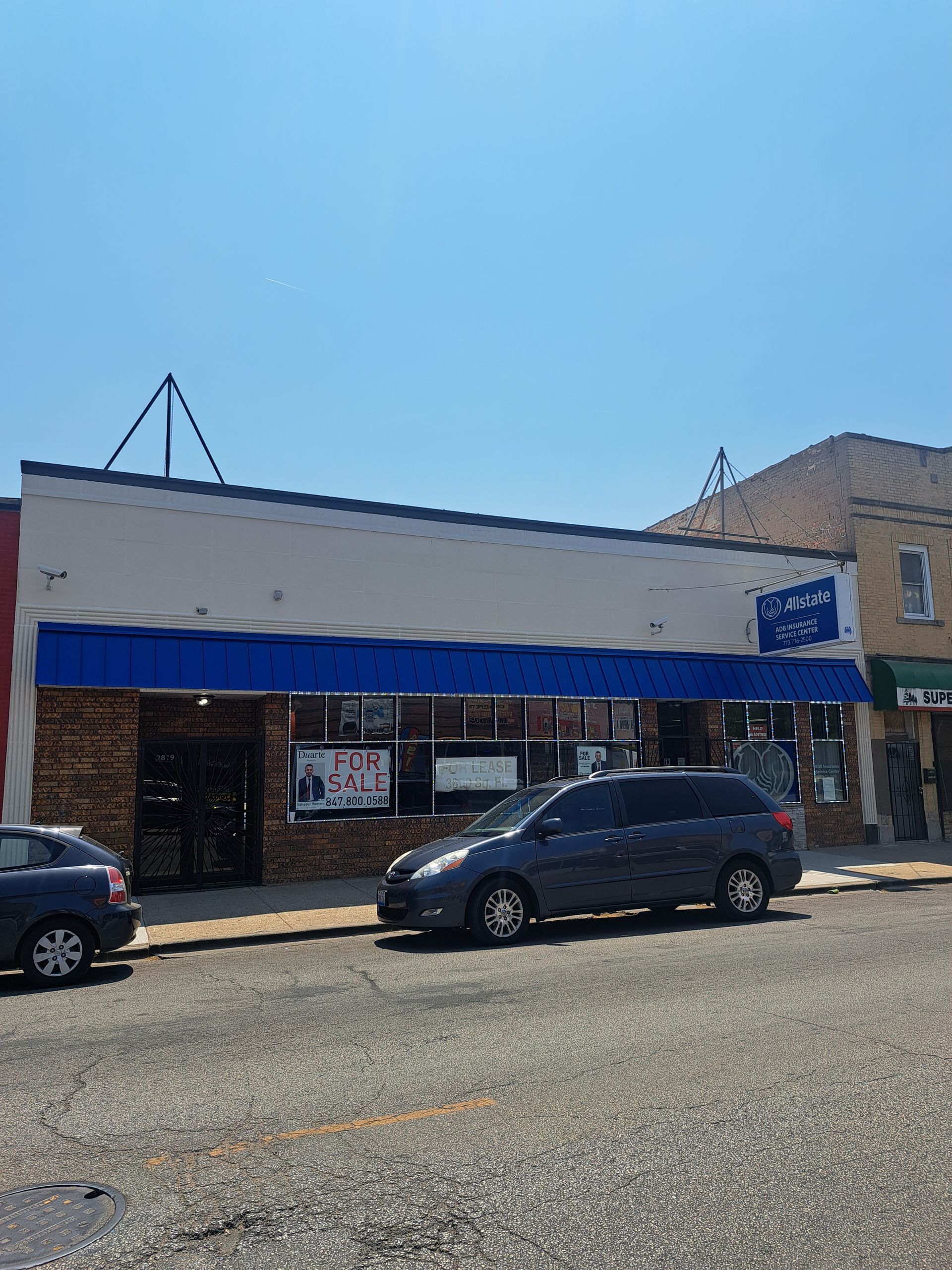 An empty room with a wooden floor and a ladder.
