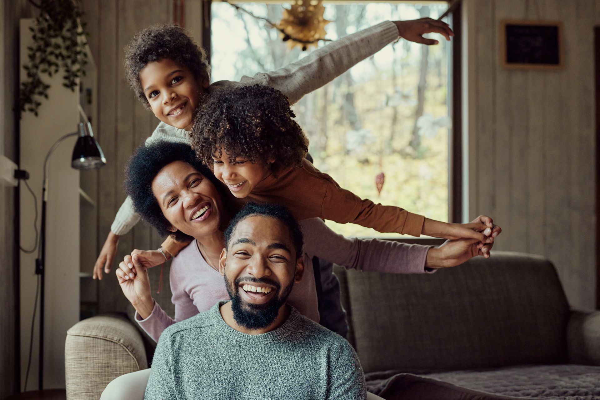A family is laying on the floor in a living room.