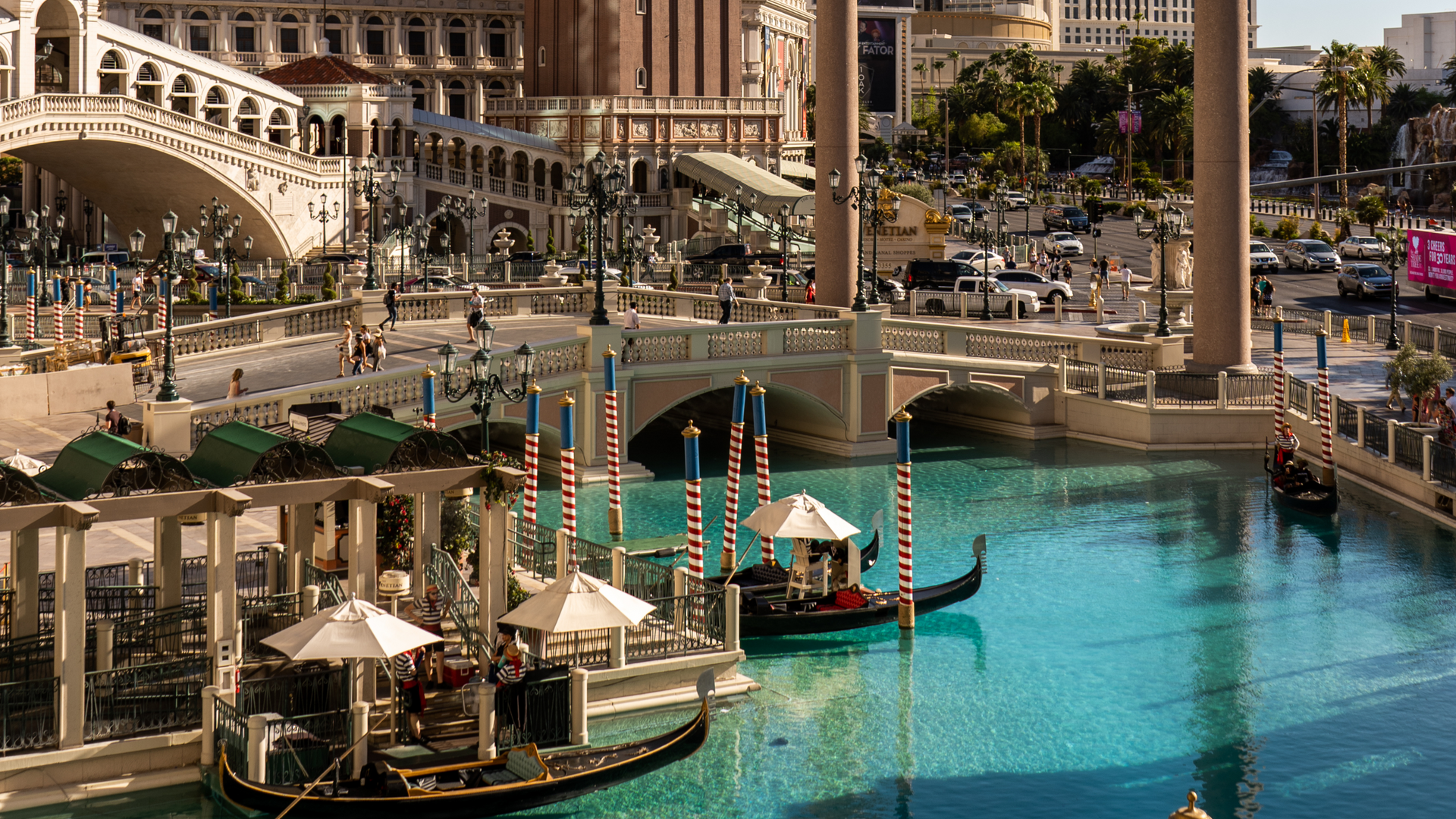 A couple of gondolas are docked in a body of water