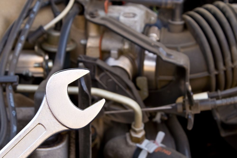 A Wrench Is Sitting On Top Of A Car Engine — Cairns Mechanical Workshop In Bungalow, QLD