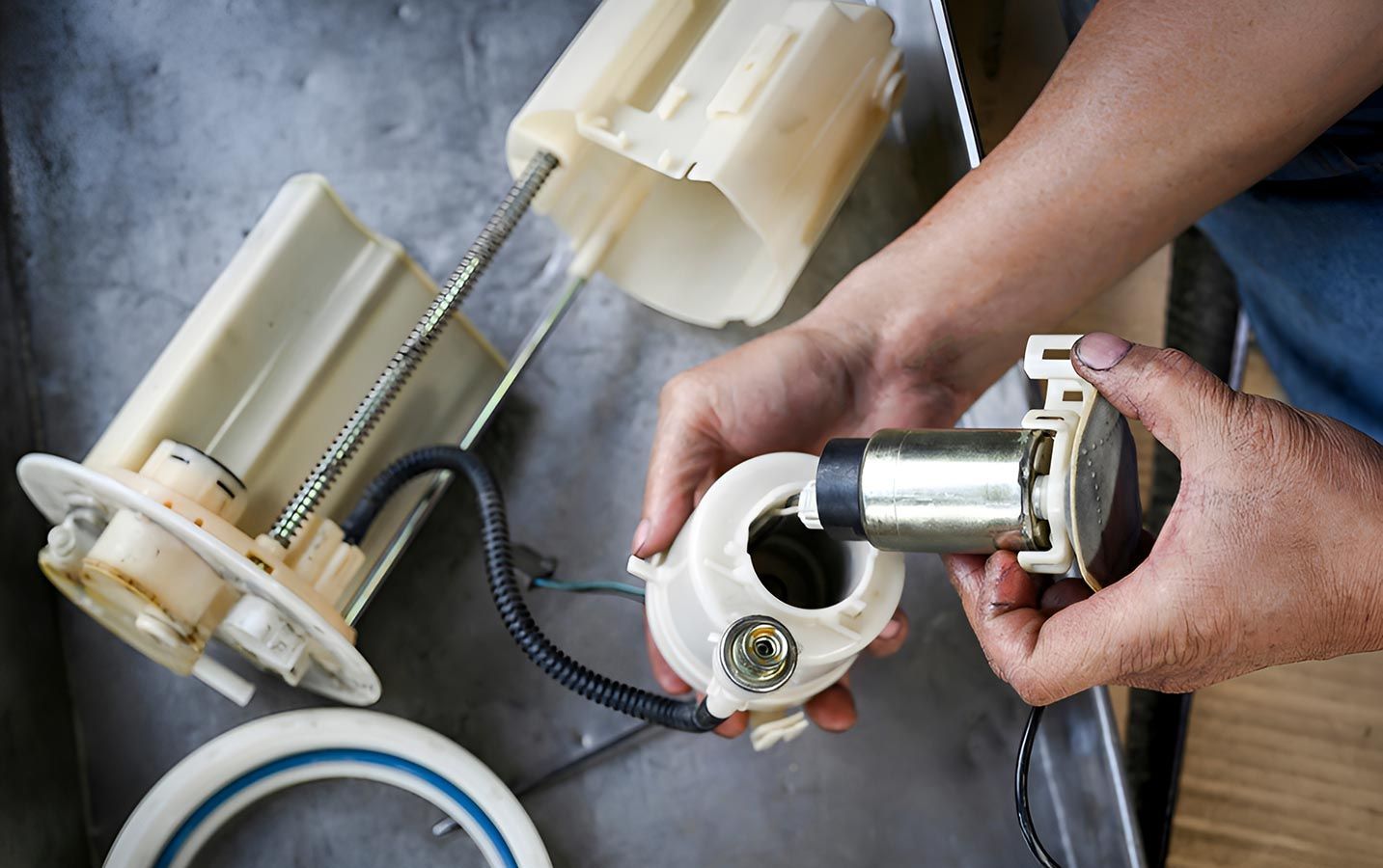 A Person is Holding a Fuel Pump in Their Hands — Cairns Mechanical Workshop In Bungalow, QLD
