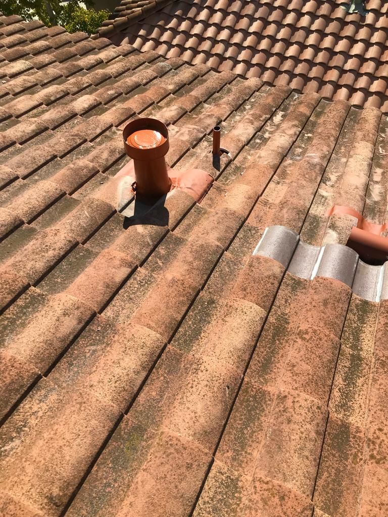 There is a chimney on the roof of a house.