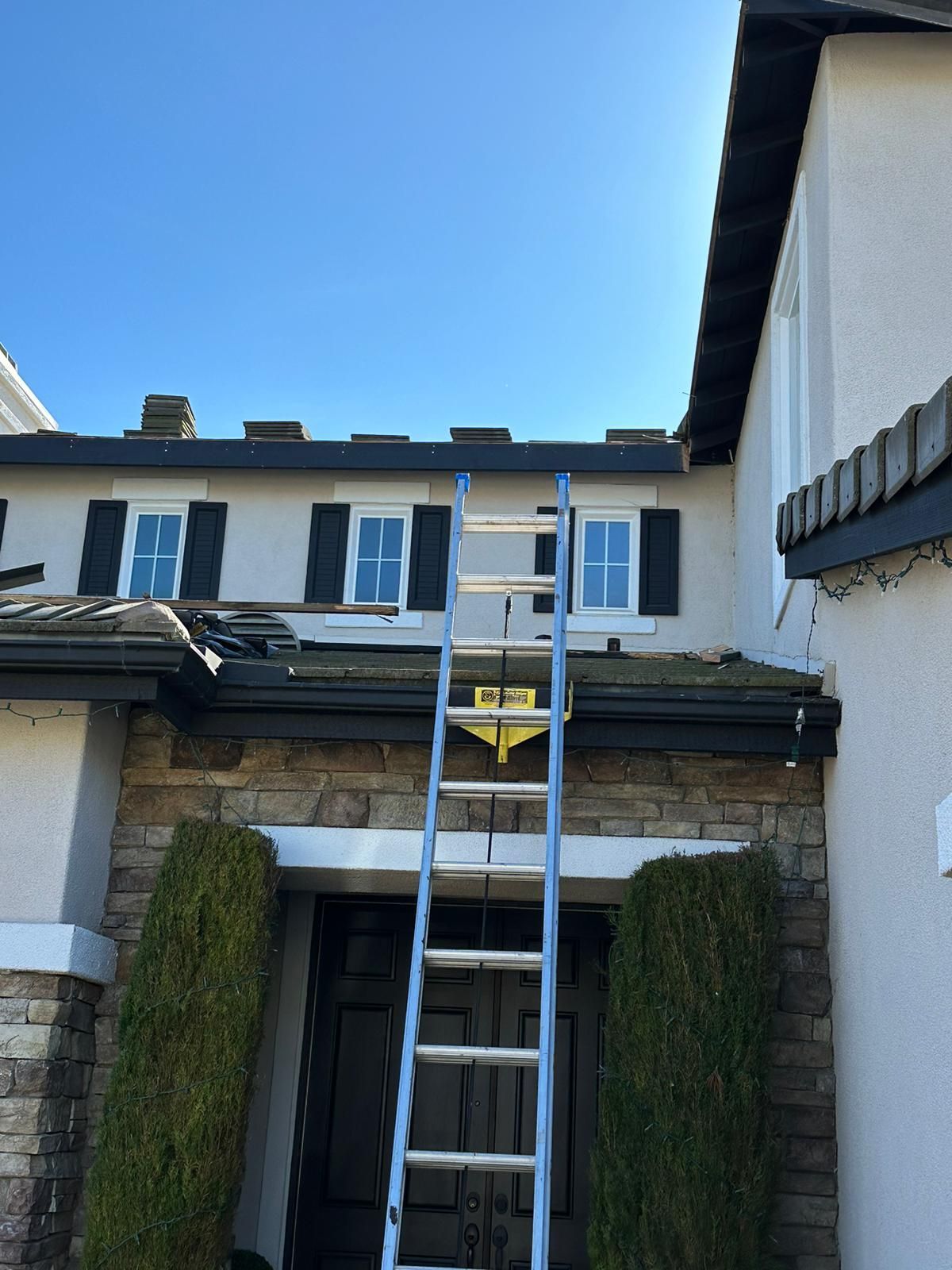 A ladder is attached to the side of a house
