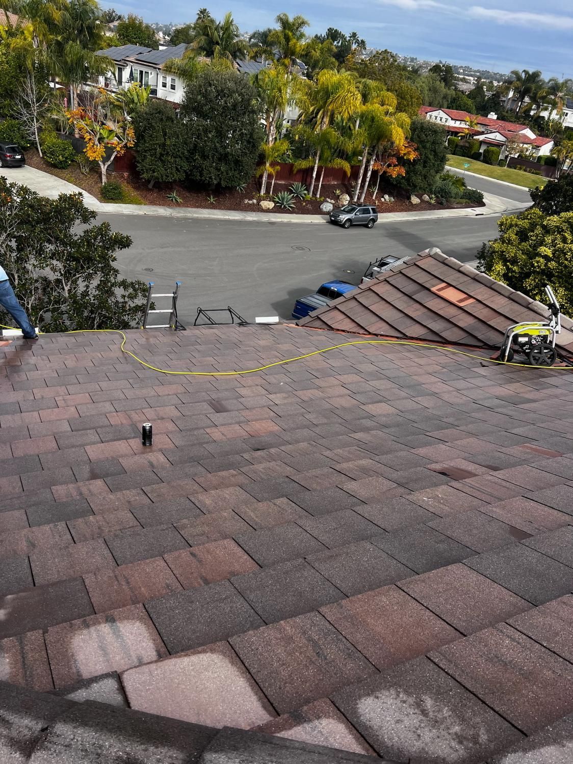 A man is working on the roof of a house.