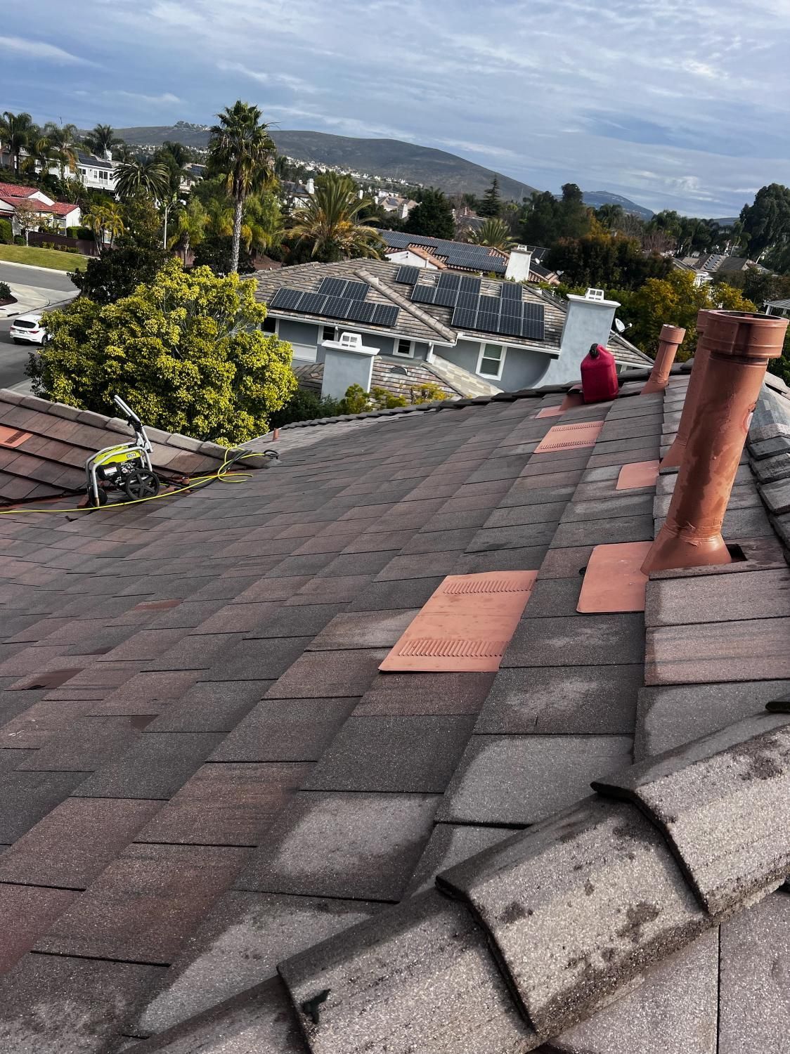 A roof with a lot of tiles on it and a chimney on it