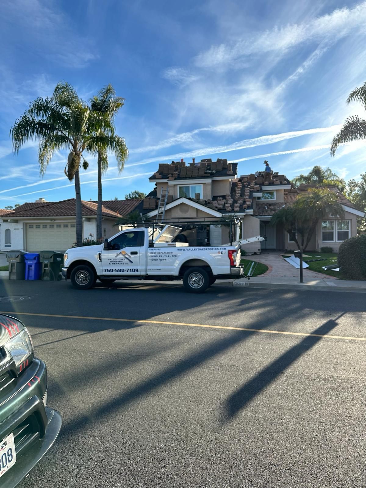 A white truck is parked in front of a house.