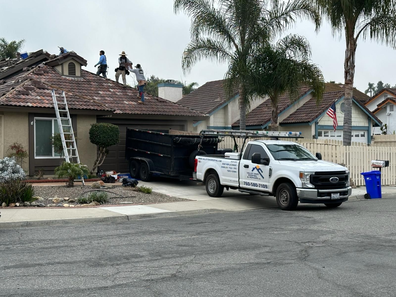 A white truck is parked in front of a house.