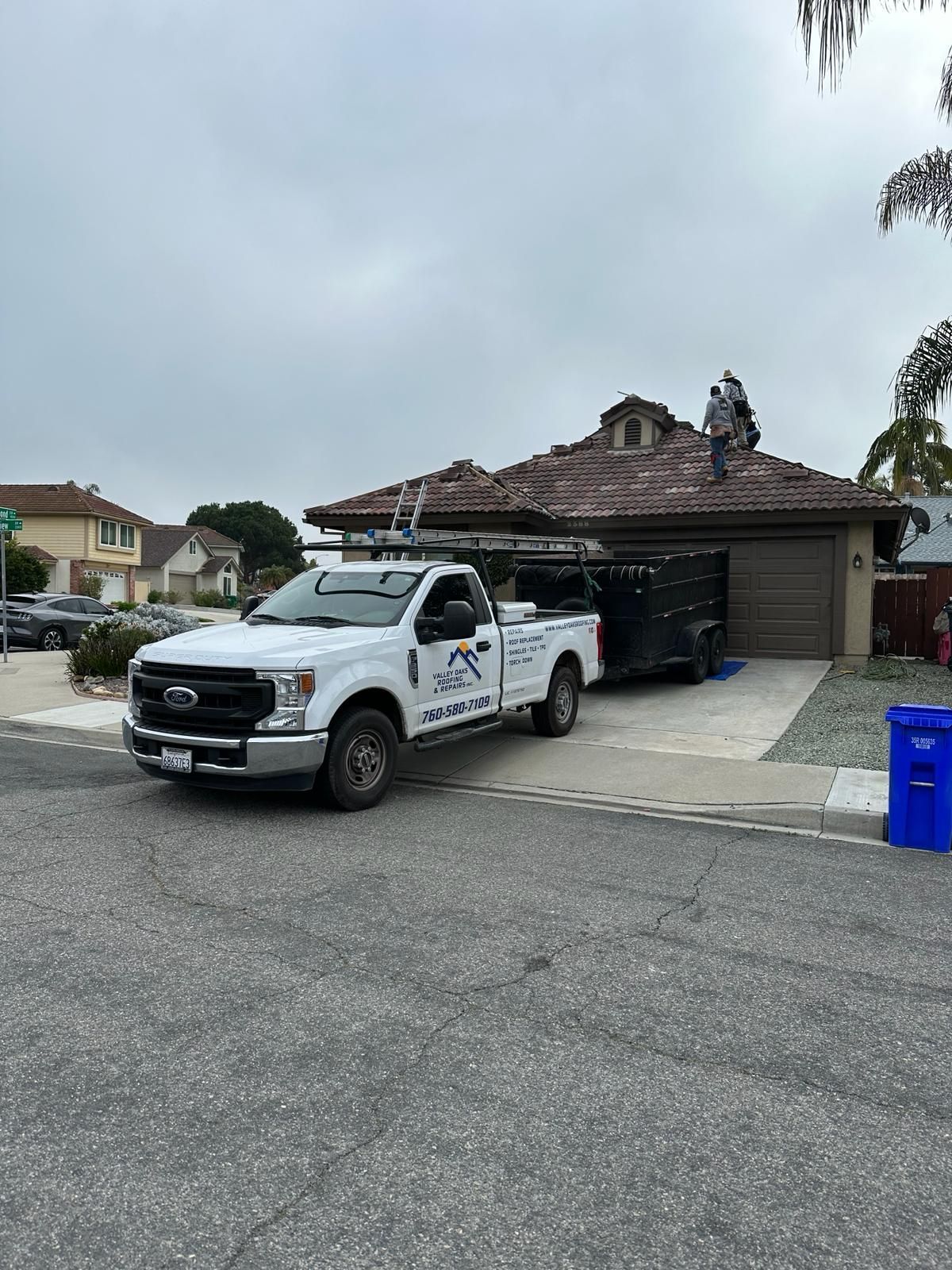 A white truck is parked in front of a house.