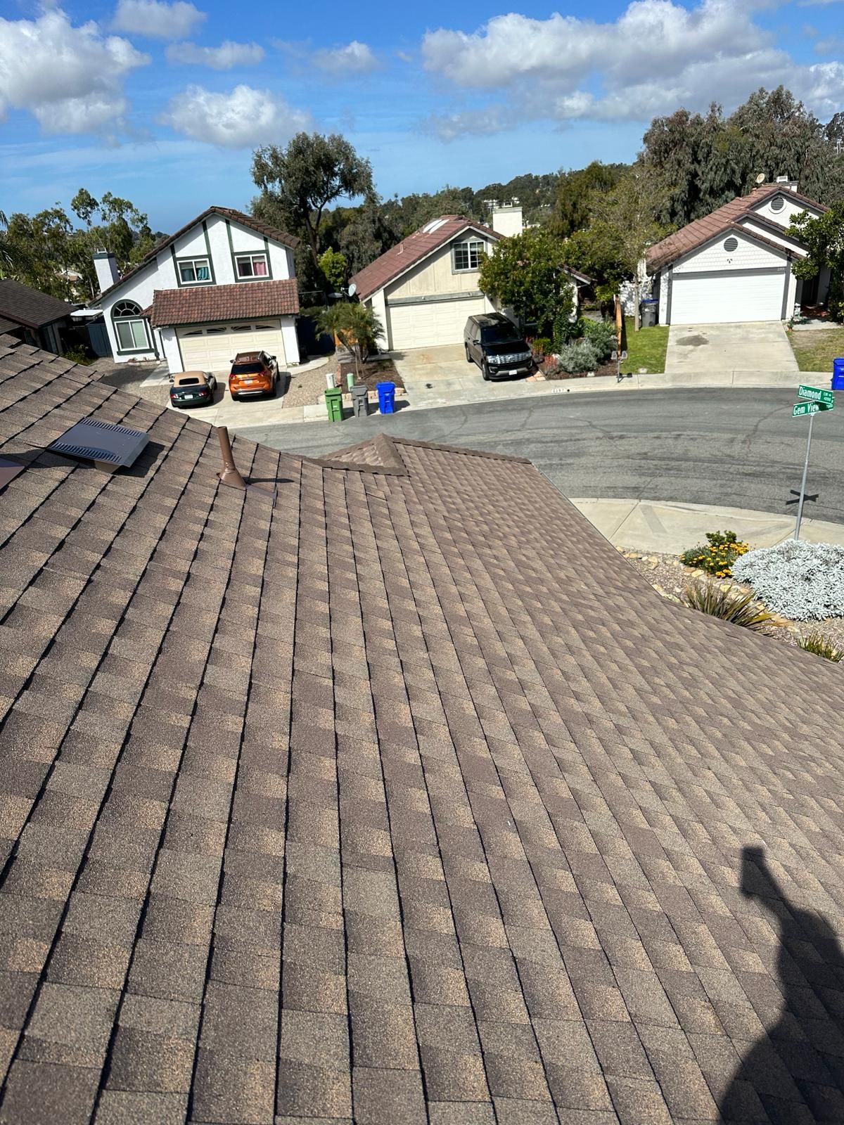 A roof with a lot of shingles on it in a residential area.