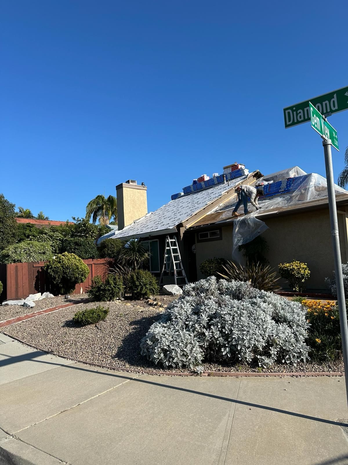 A house is being remodeled with a roof being installed.