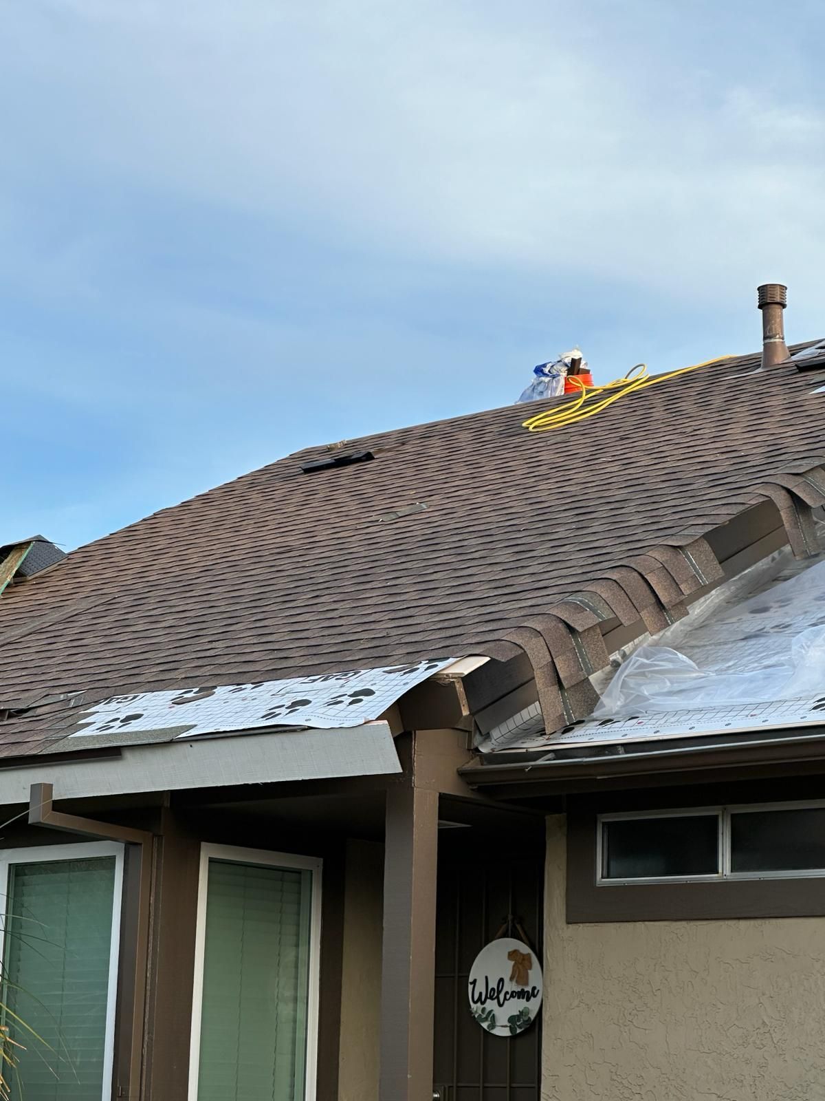 A man is working on the roof of a house.