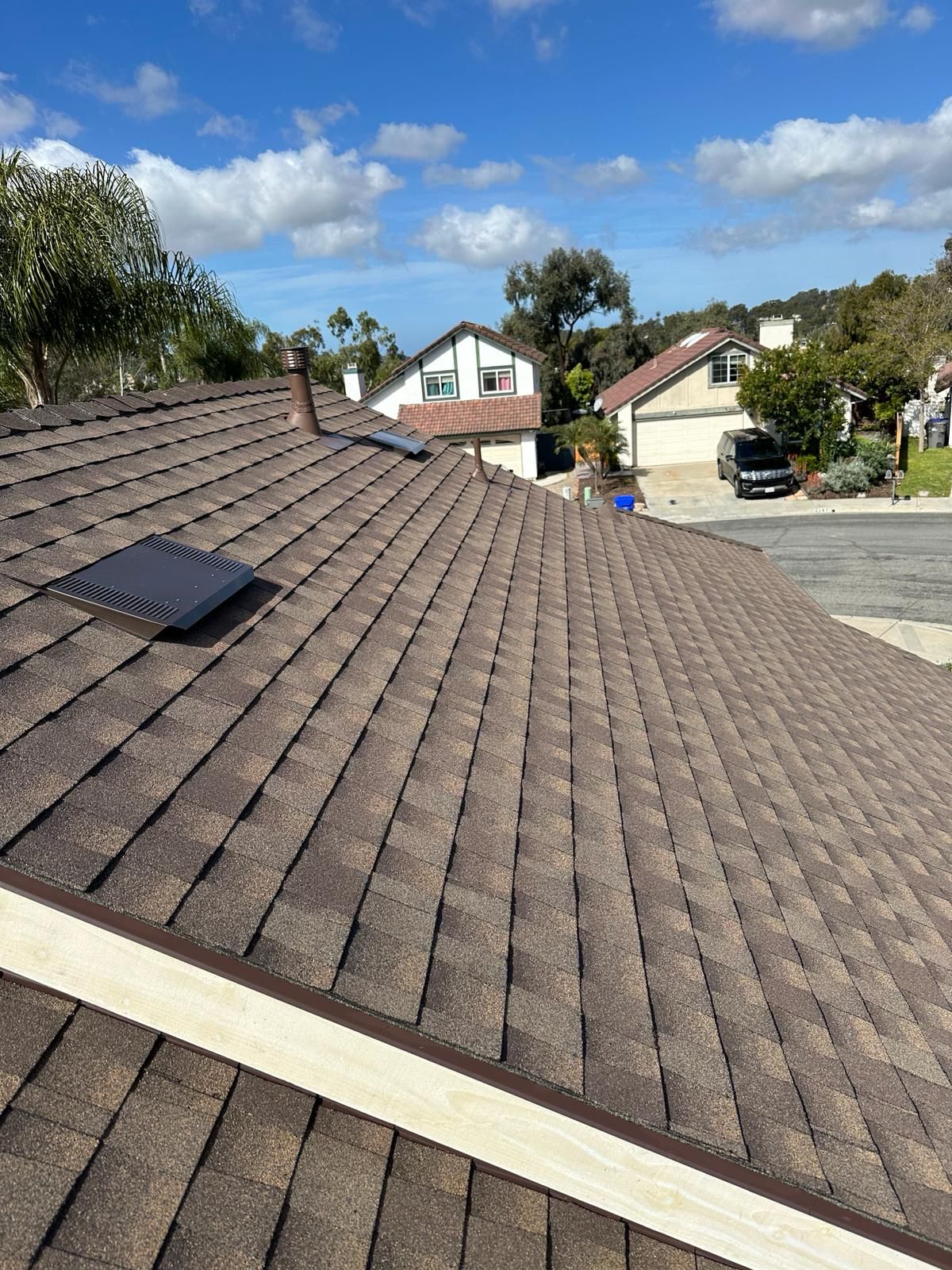 A close up of a roof with two skylights on it.