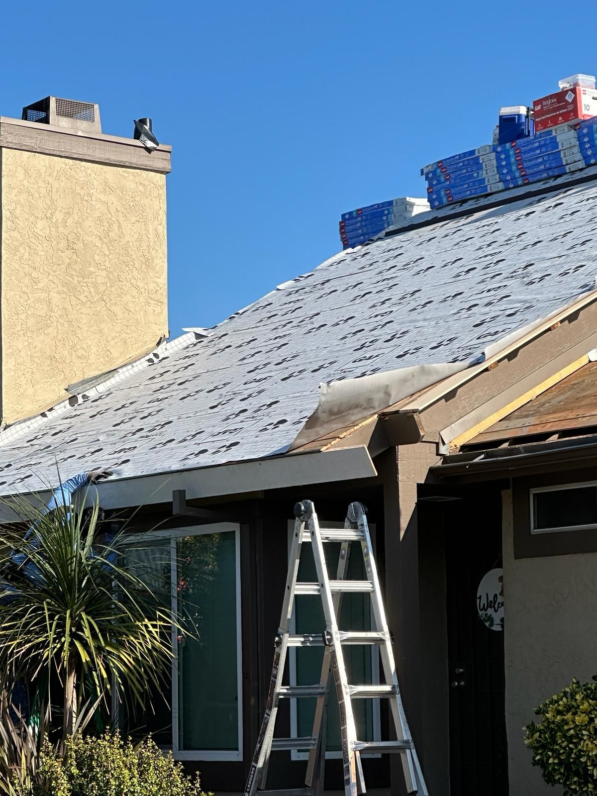 A house with a ladder sitting in front of it