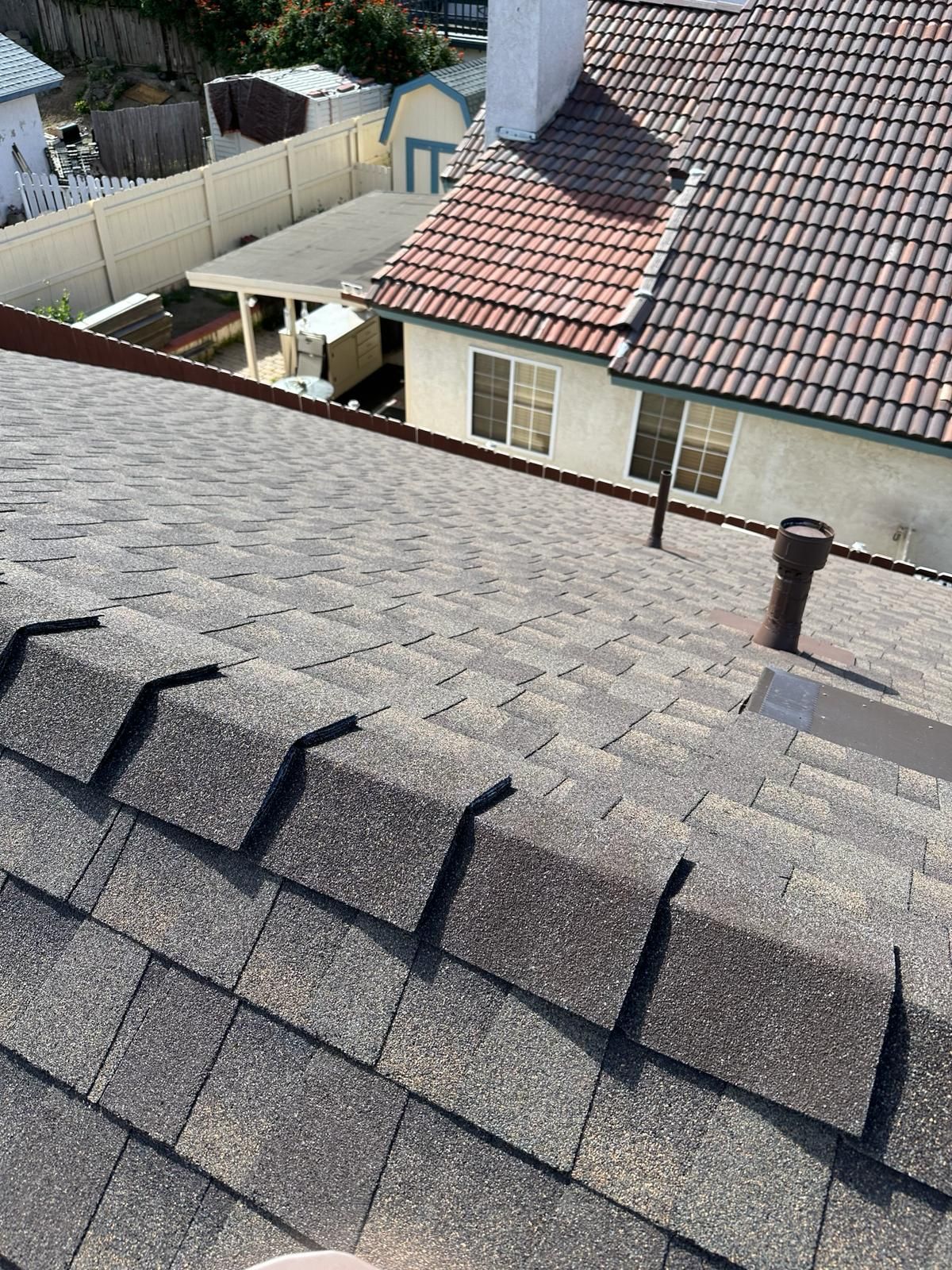 A person is standing on the roof of a house.