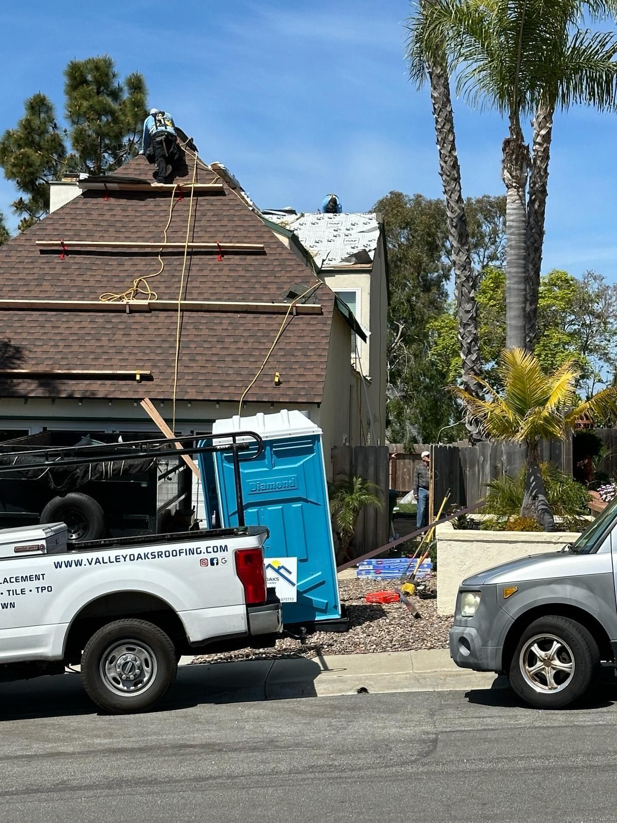 A truck is parked in front of a house under construction.