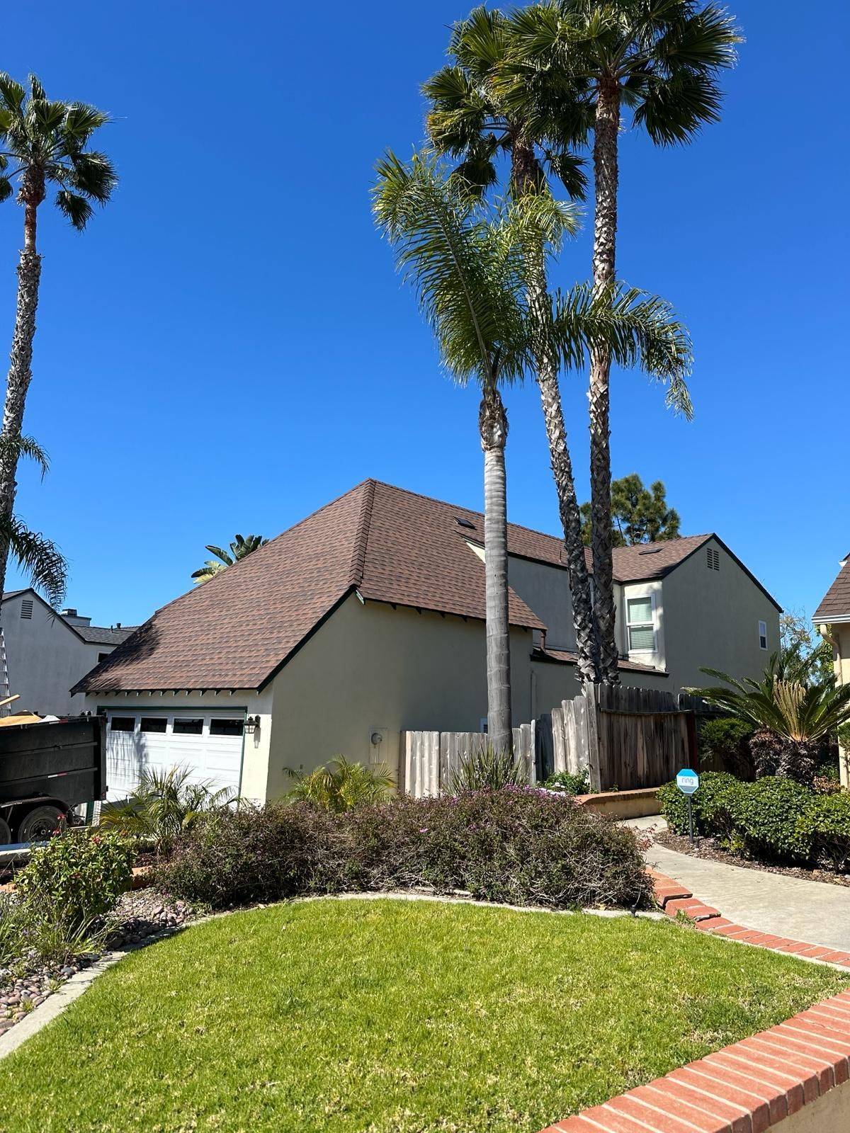 A house with two palm trees in front of it