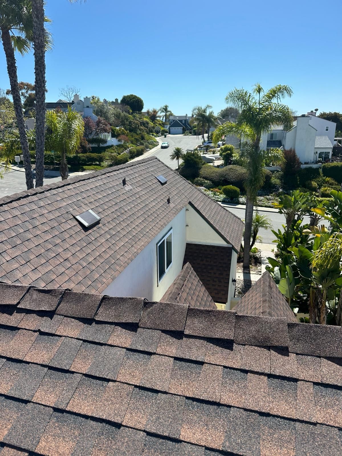 An aerial view of a house with a roof that has shingles on it.