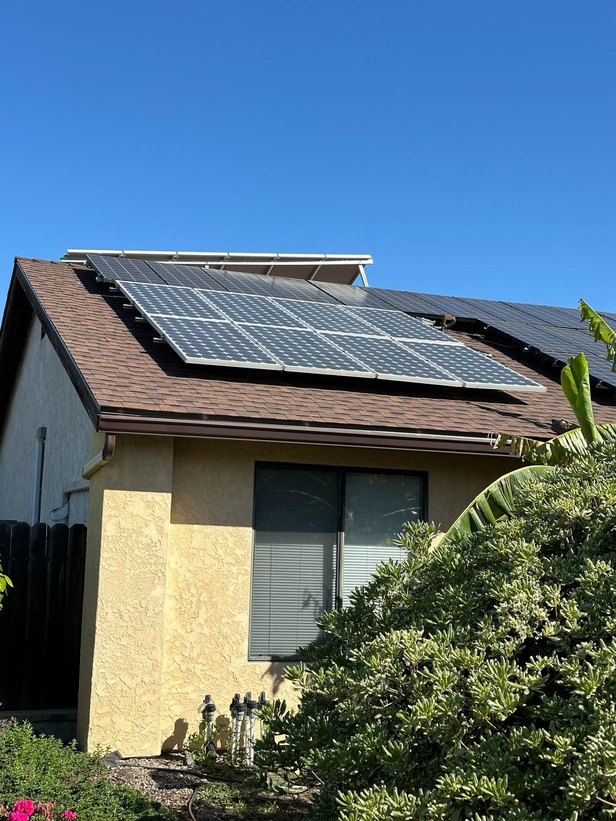 A house with a lot of solar panels on the roof.