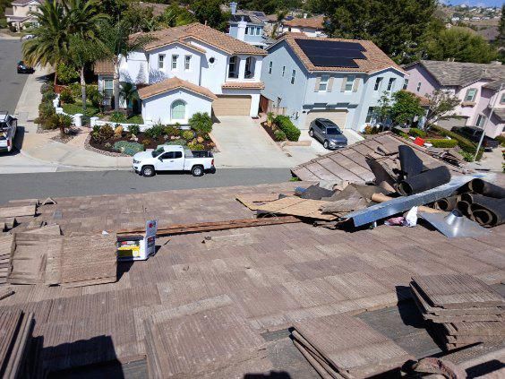 A white truck is parked on the roof of a house