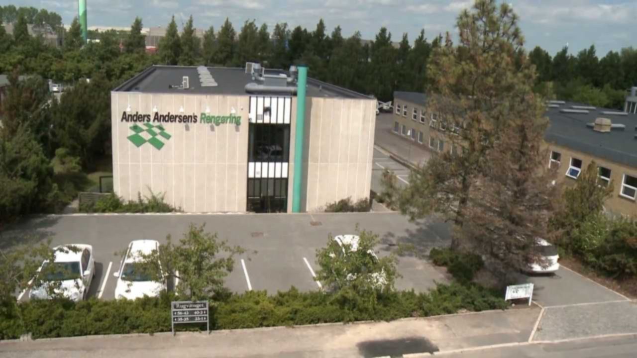 An aerial view of a large building with the word aalborg on it