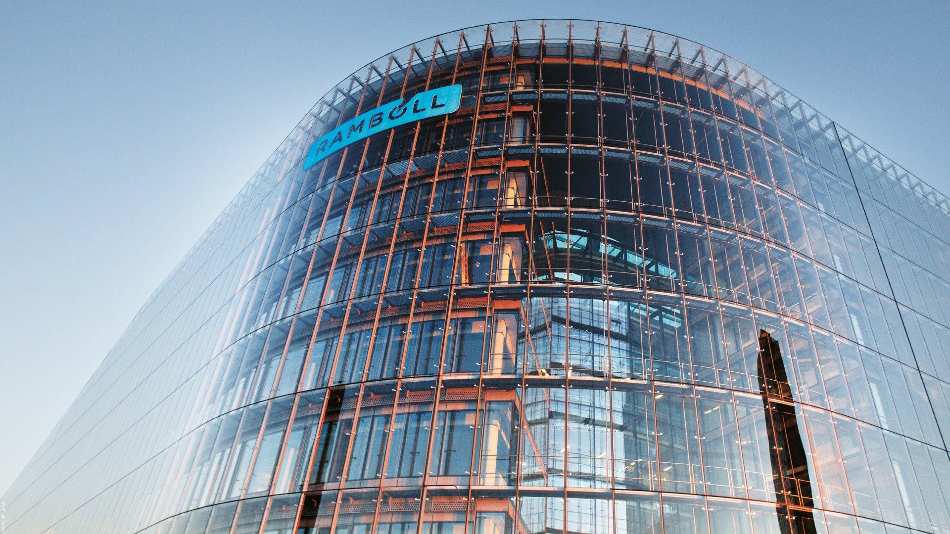 A tall building with a blue sign that says ' siemens ' on it