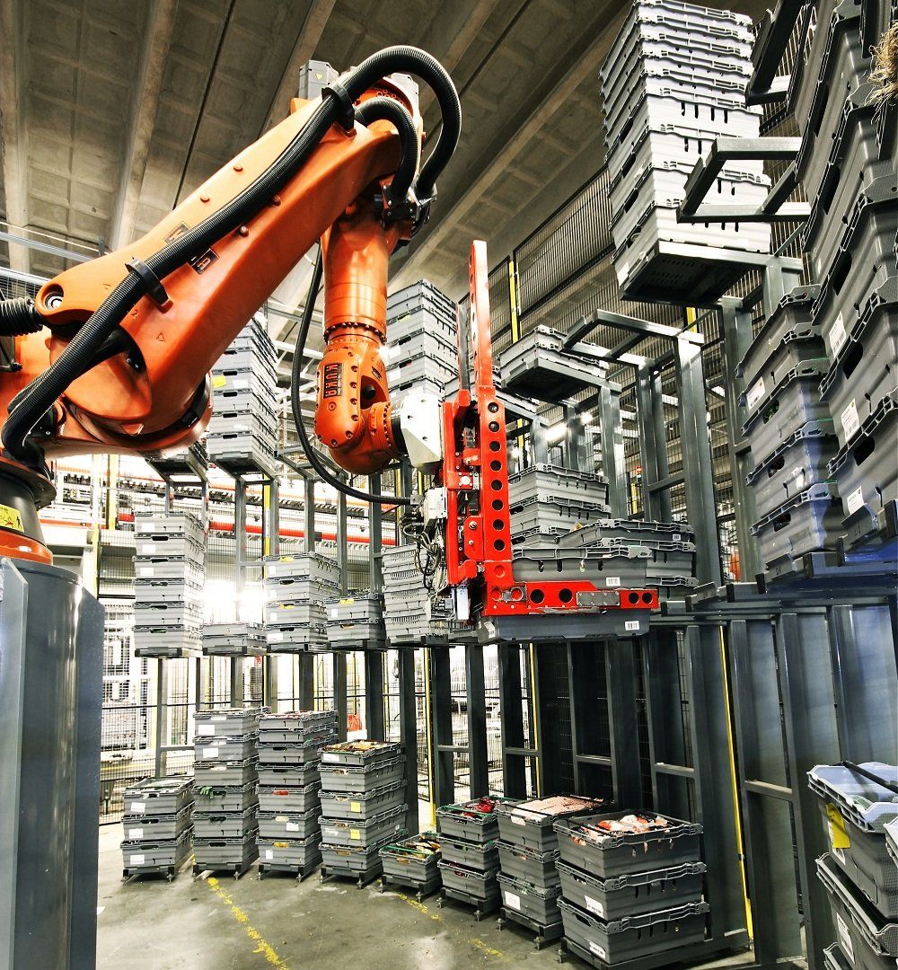 A robotic arm is working in a warehouse full of boxes