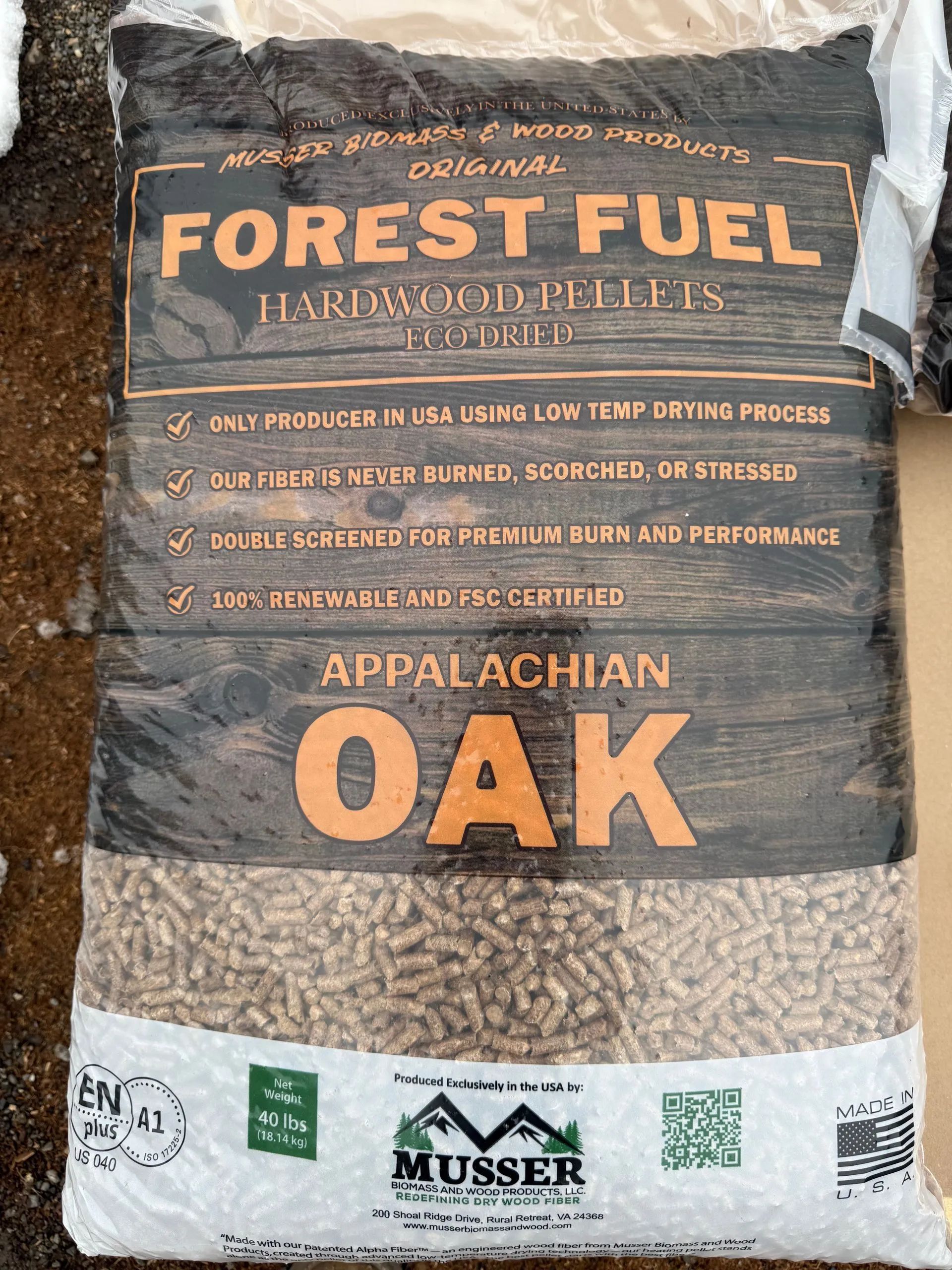 A bag of Forest Fuel Appalachian Oak hardwood pellets by Musser, featuring product details against a wood-grain background.