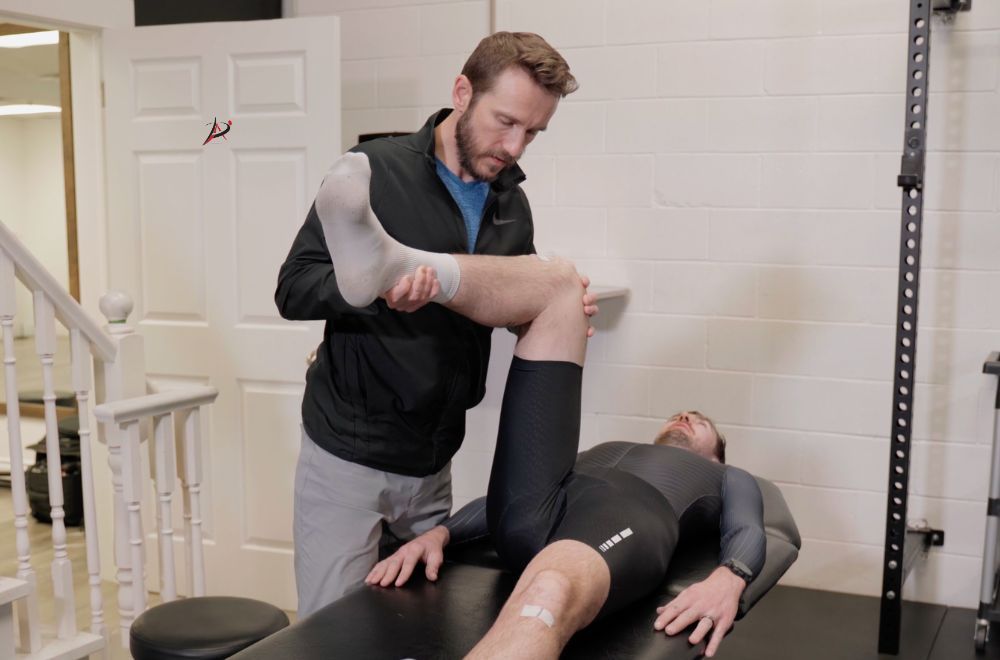 Image of a cyclist having their knee examined