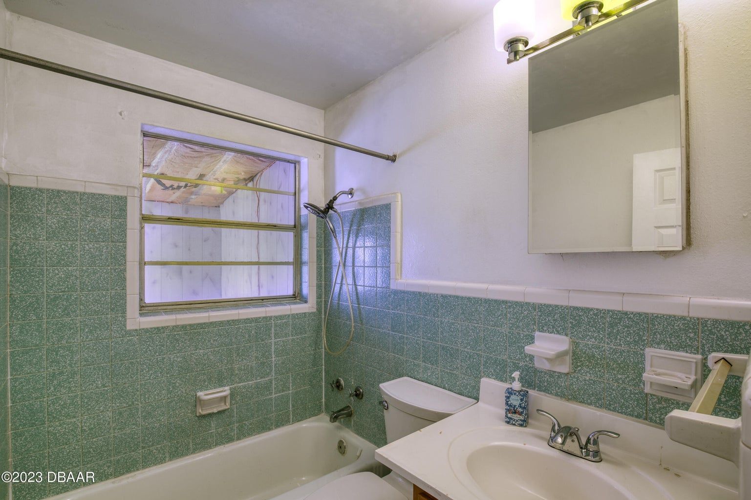 a bathroom with green tile