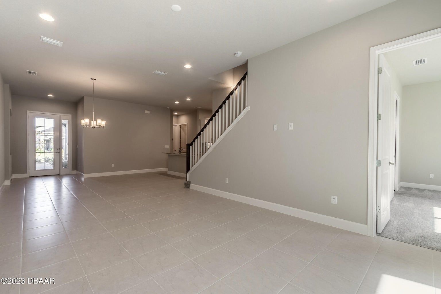 an empty room with stairs leading up to the second floor