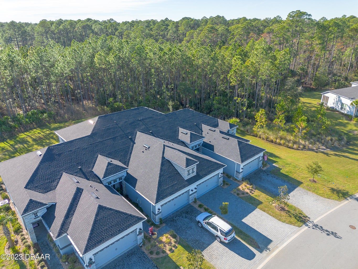 an aerial view of a house with a van parked in front of it