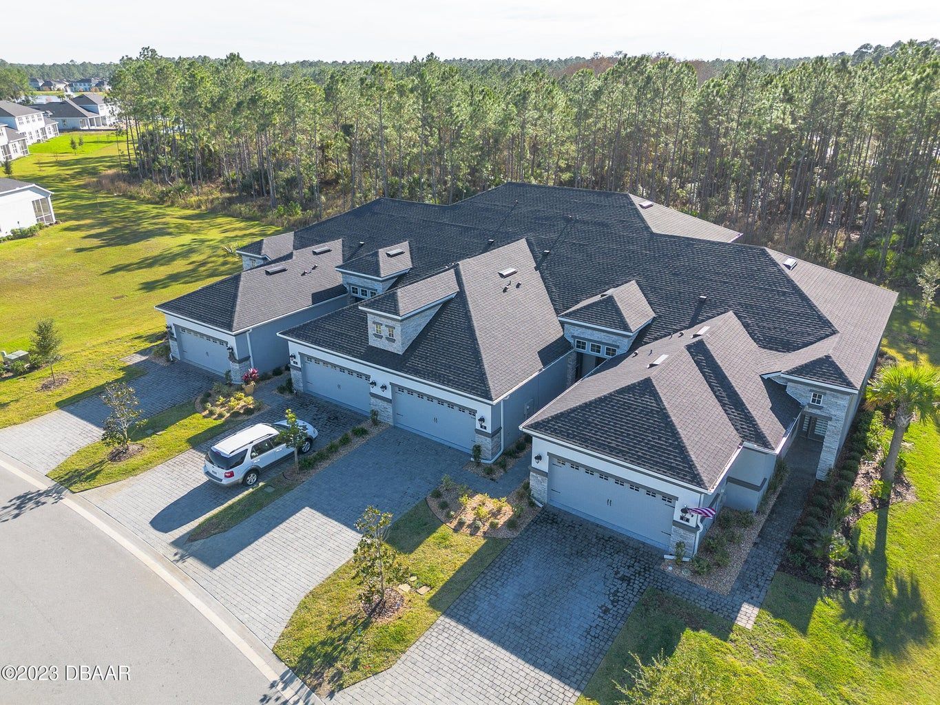 an aerial view of a house with a black roof