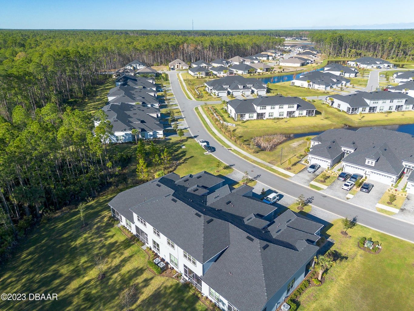 an aerial view of a residential area with lots of houses and trees