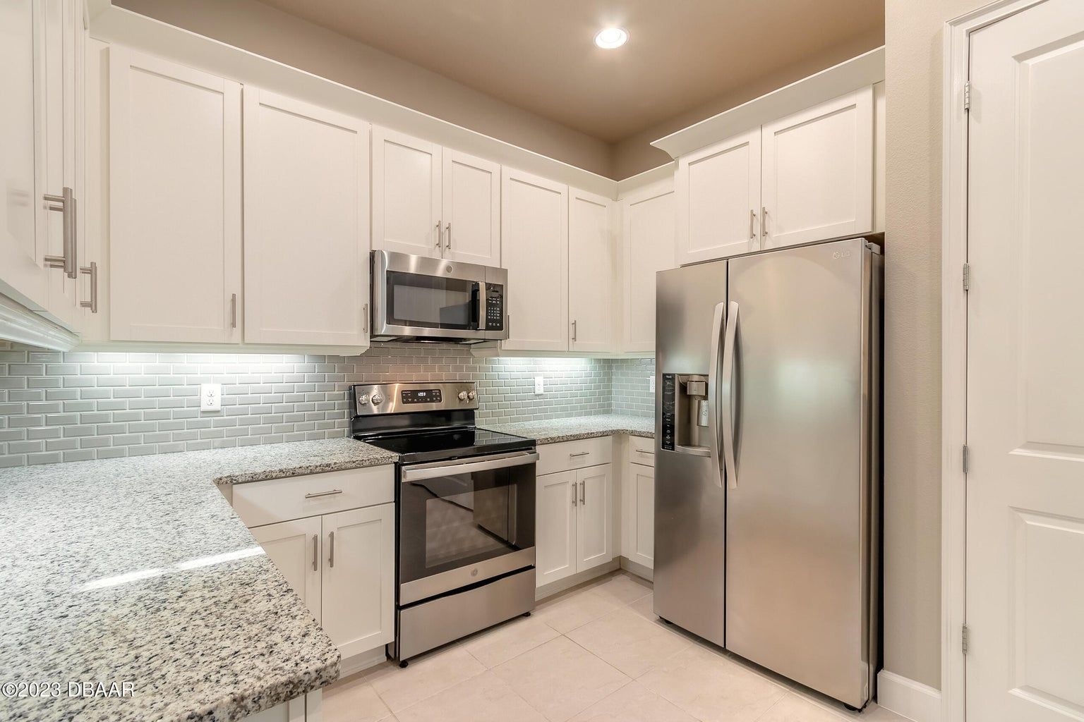 a kitchen with stainless steel appliances and granite counter tops