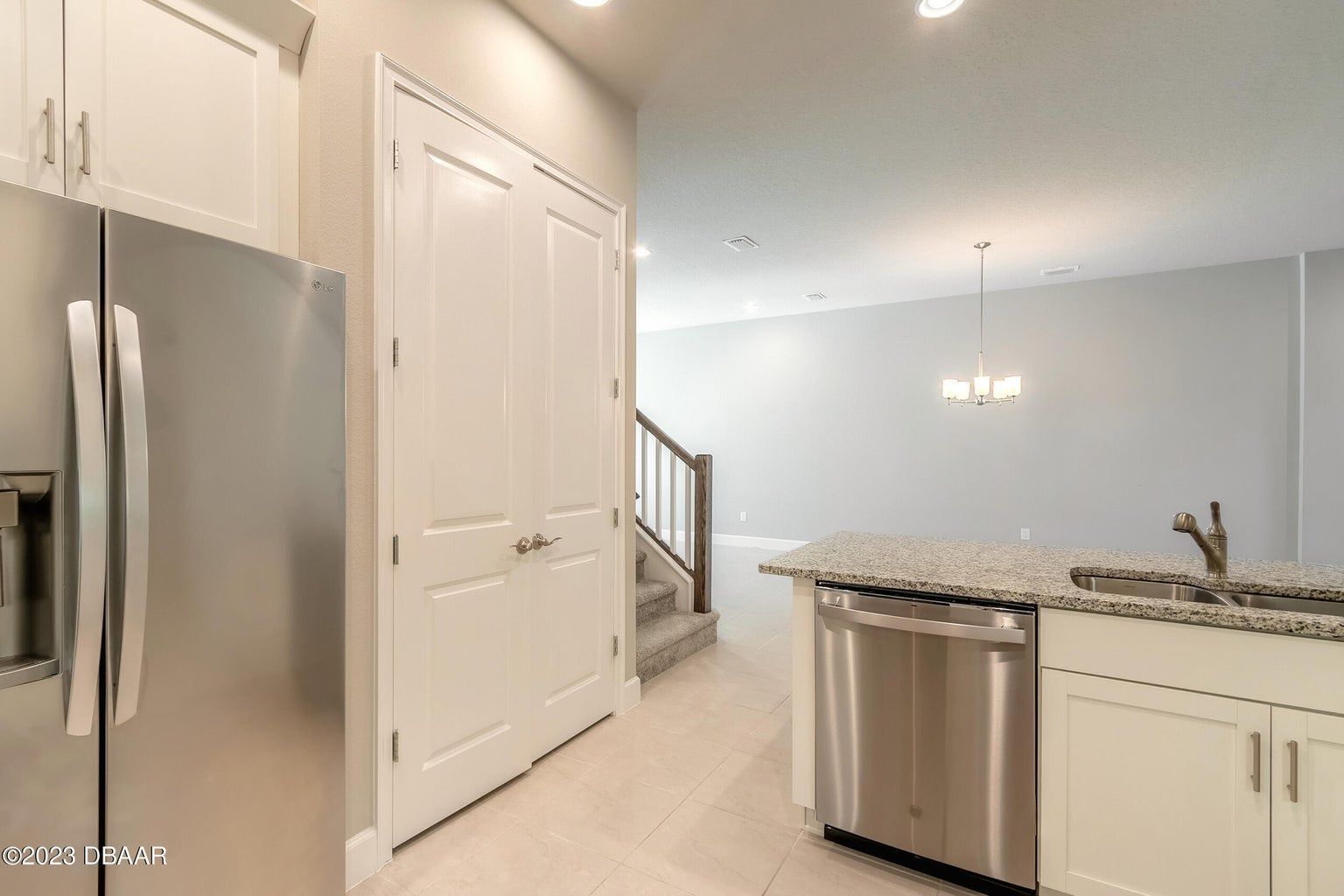 a kitchen with stainless steel appliances and white cabinets