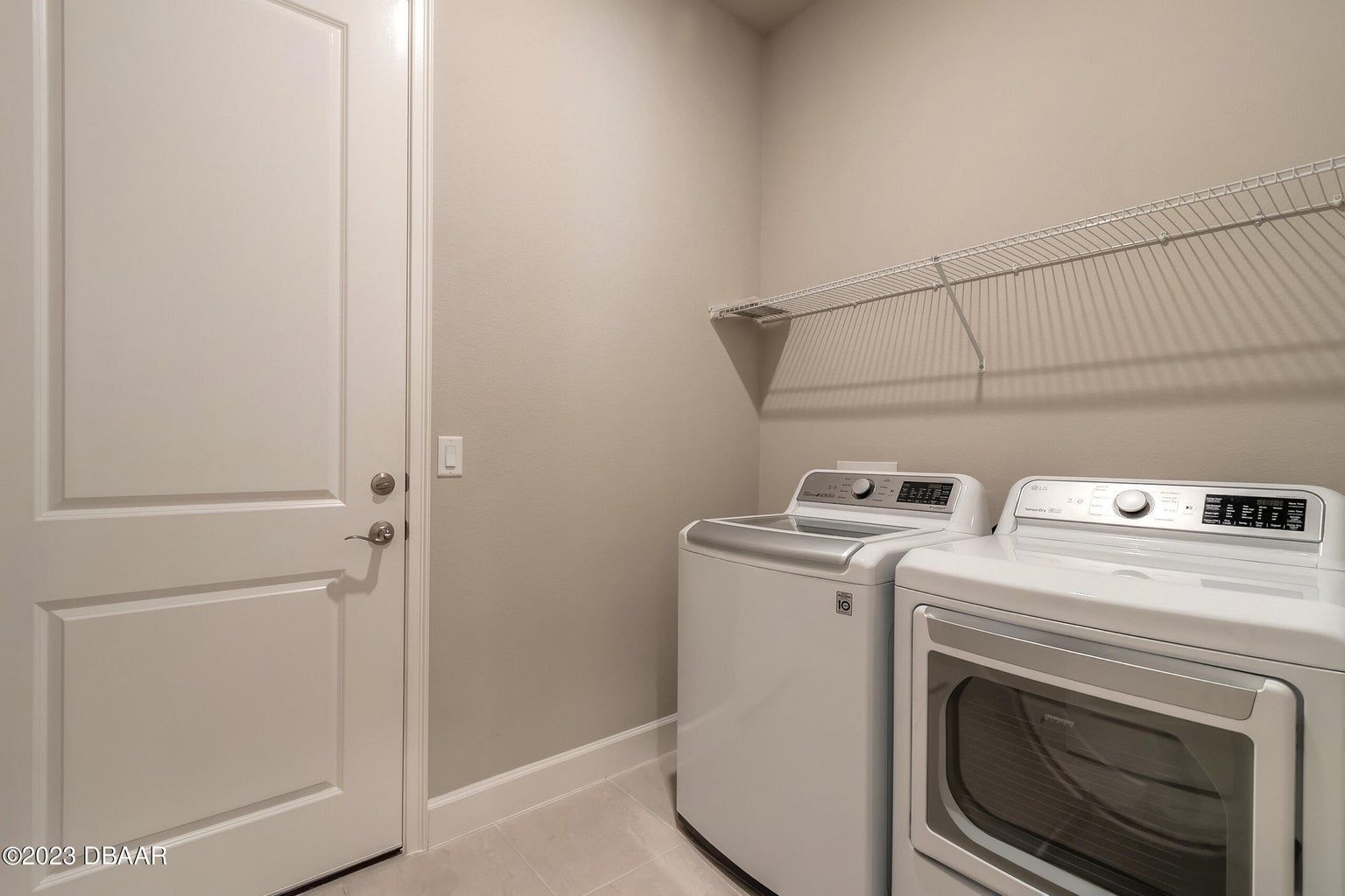 a laundry room with a washer and dryer and a door .