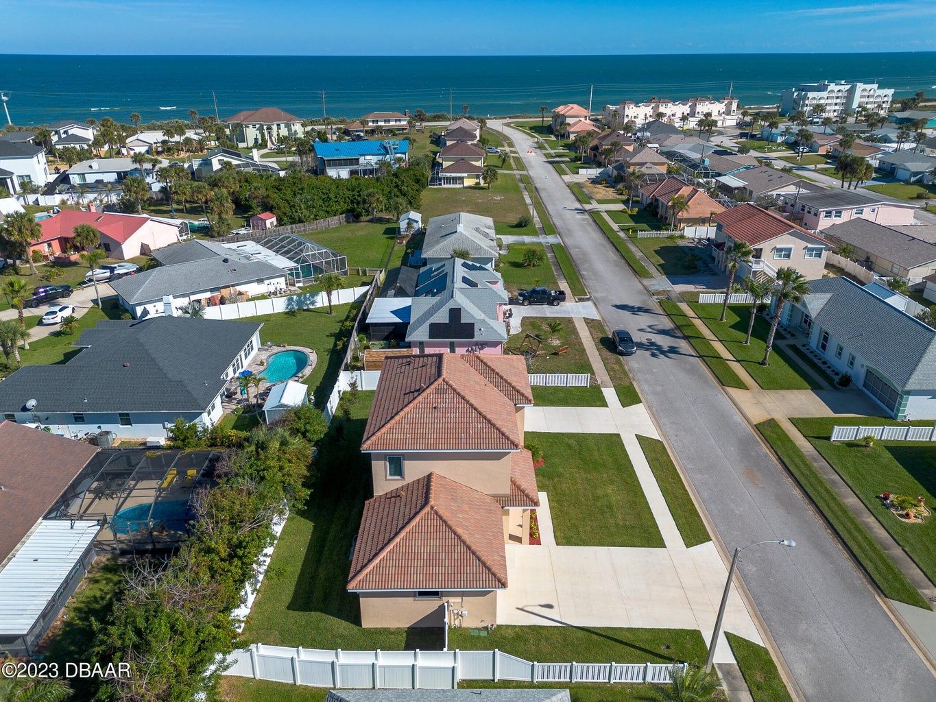 an aerial view of a residential area near the ocean