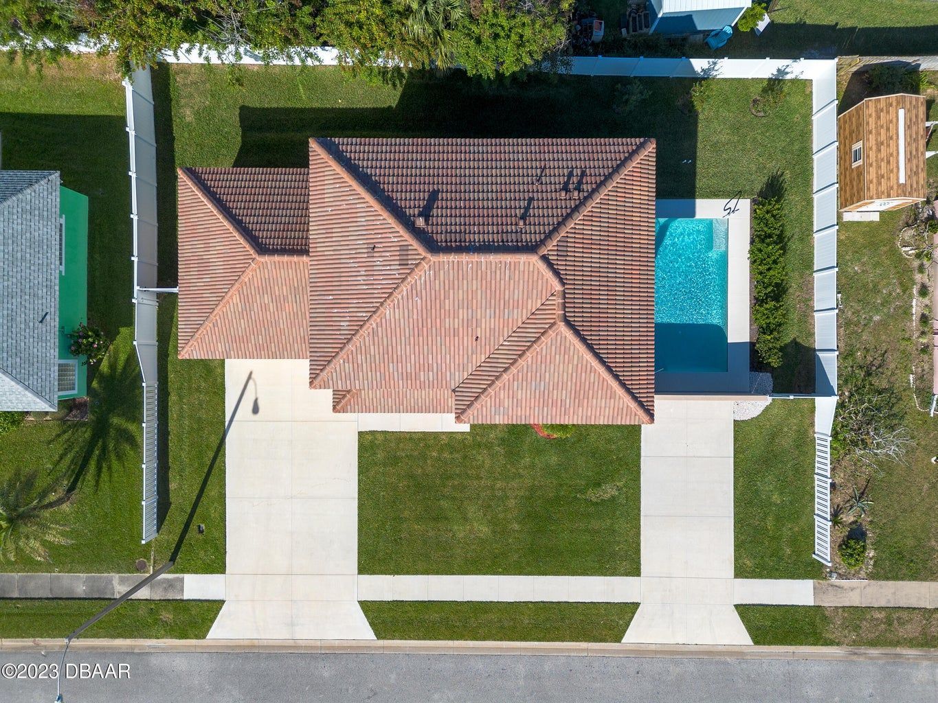 an aerial view of a house with a pool in the backyard