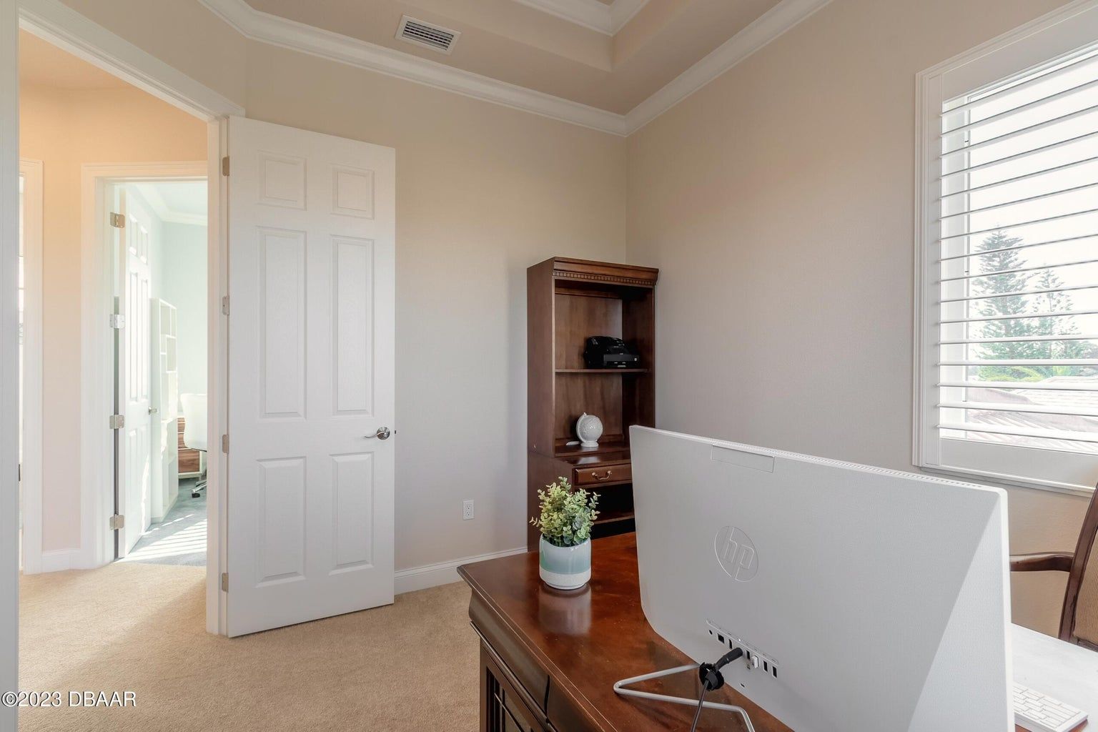 a home office with a desk and a computer on it