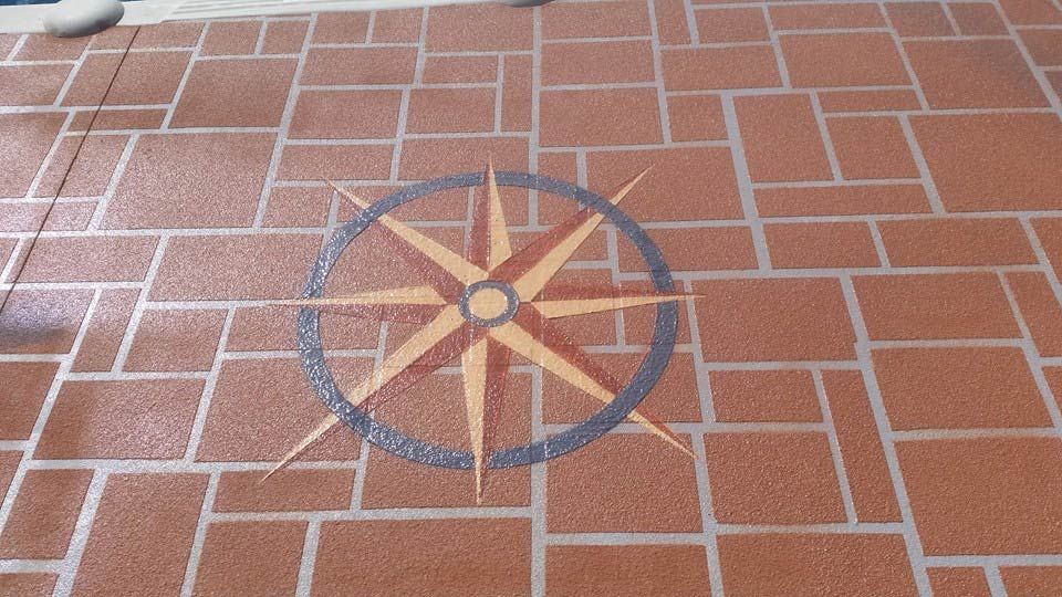 A Compass Is Painted On A Brick Floor — Custom Concrete Finishes In Thurgoona, NSW