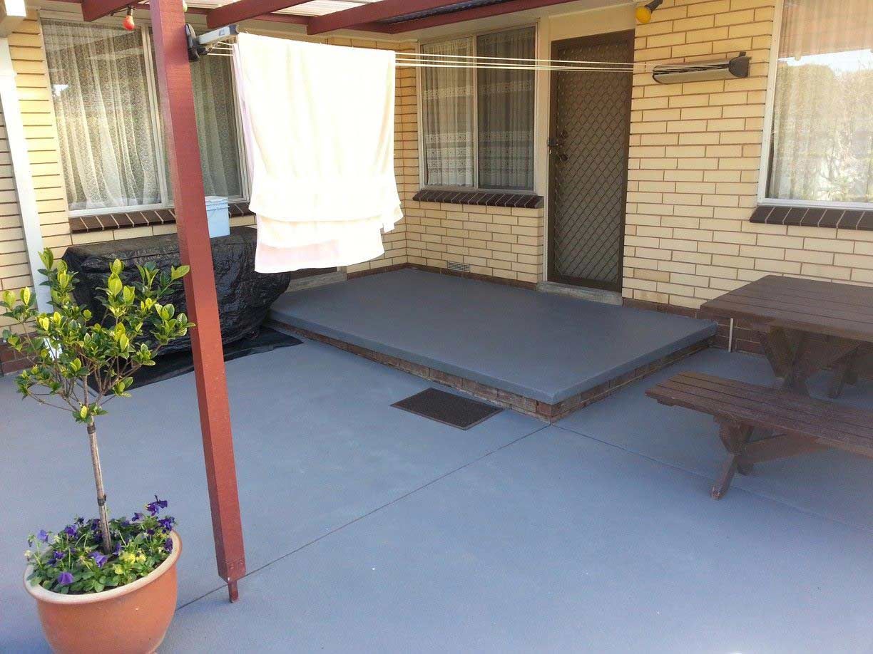 A Patio With A Picnic Table And A Potted Plant — Custom Concrete Finishes In Wodonga, NSW