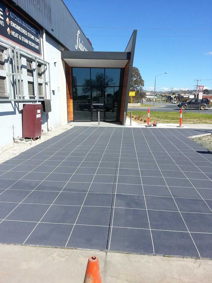 A Large Building With A Concrete Driveway In Front Of It — Custom Concrete Finishes In Albury, NSW