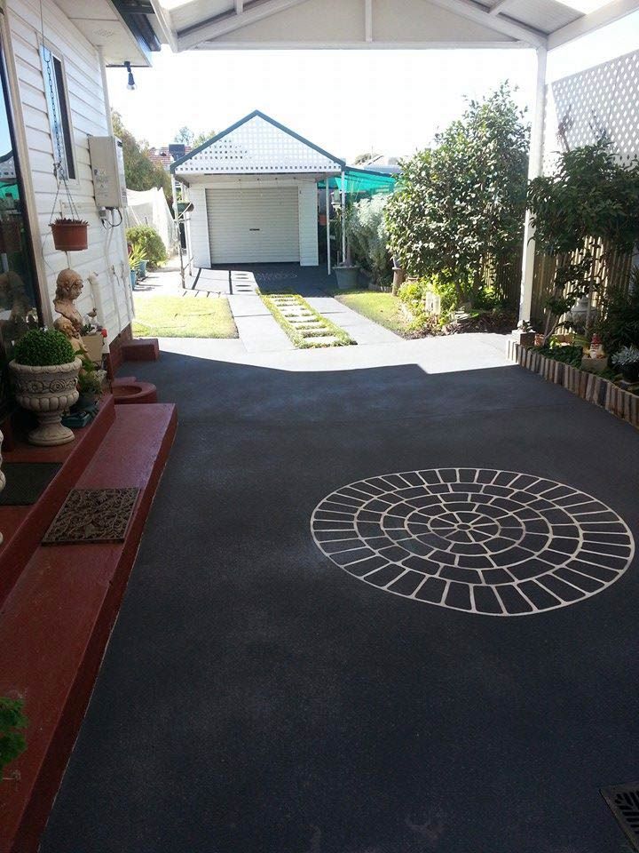 A Driveway With A Circular Design In The Middle Of It — Custom Concrete Finishes In Thurgoona, NSW