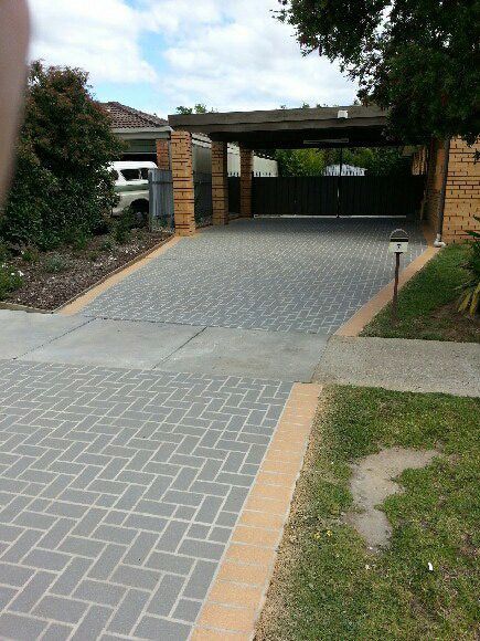 A Brick Driveway Leading To A House With A Car Parked In It — Custom Concrete Finishes In Killara, NSW